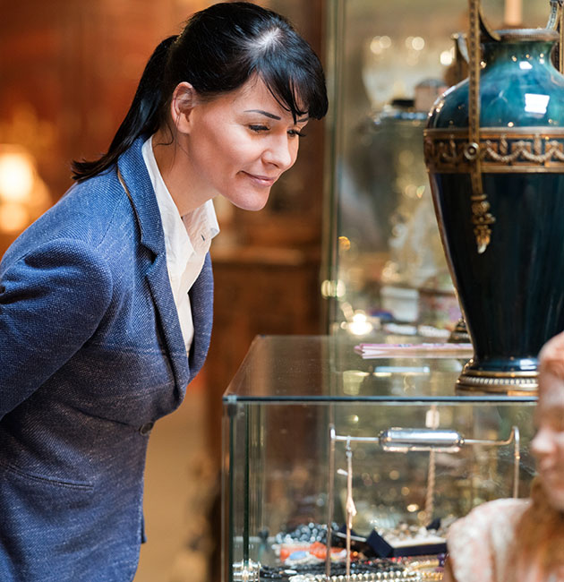 Woman looking at antiques at Roadshow's 400 Antiques Mall