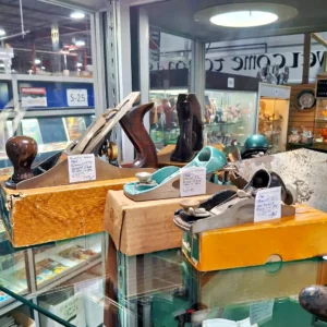 Collection of antique Stanley woodworking planes, including smooth and block planes, displayed in their original vintage boxes.