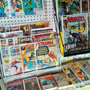 Organized retail display of vintage Marvel and DC comic books including Strange Tales and The Avengers.