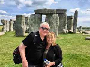 Henry Jones and Jackie posing for a photo in front of the historic Stonehenge monument.