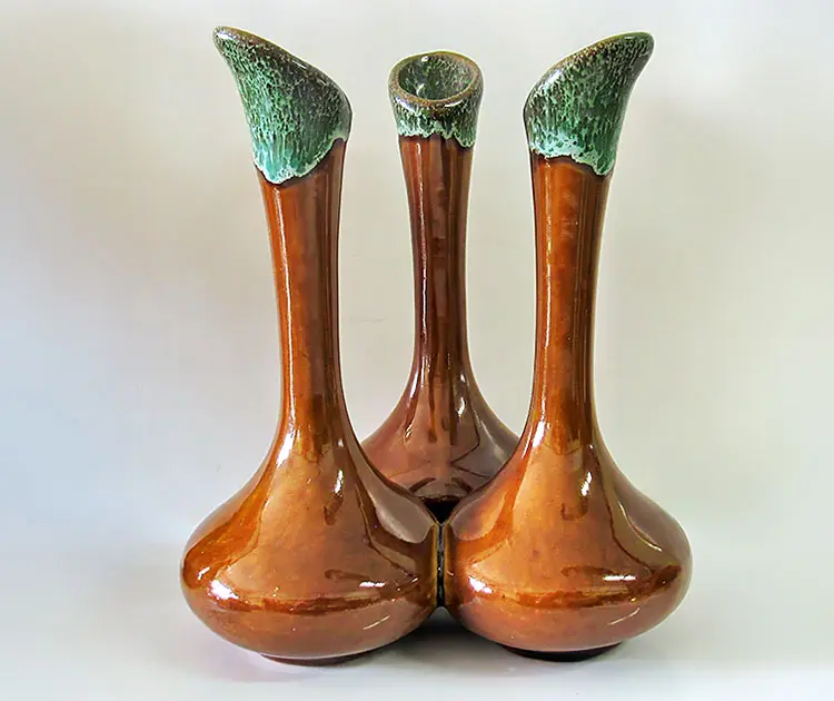 Vintage triple-neck ceramic vase with amber glaze and green drip finish, a typical piece found on the shelves of Roadshow's 400 Antiques Mall